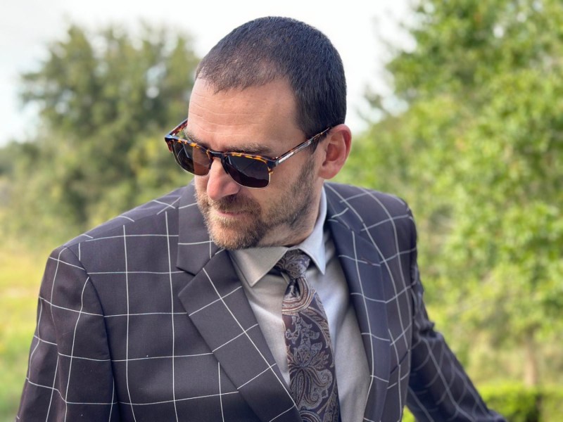 Man in tan dress shirt and suit