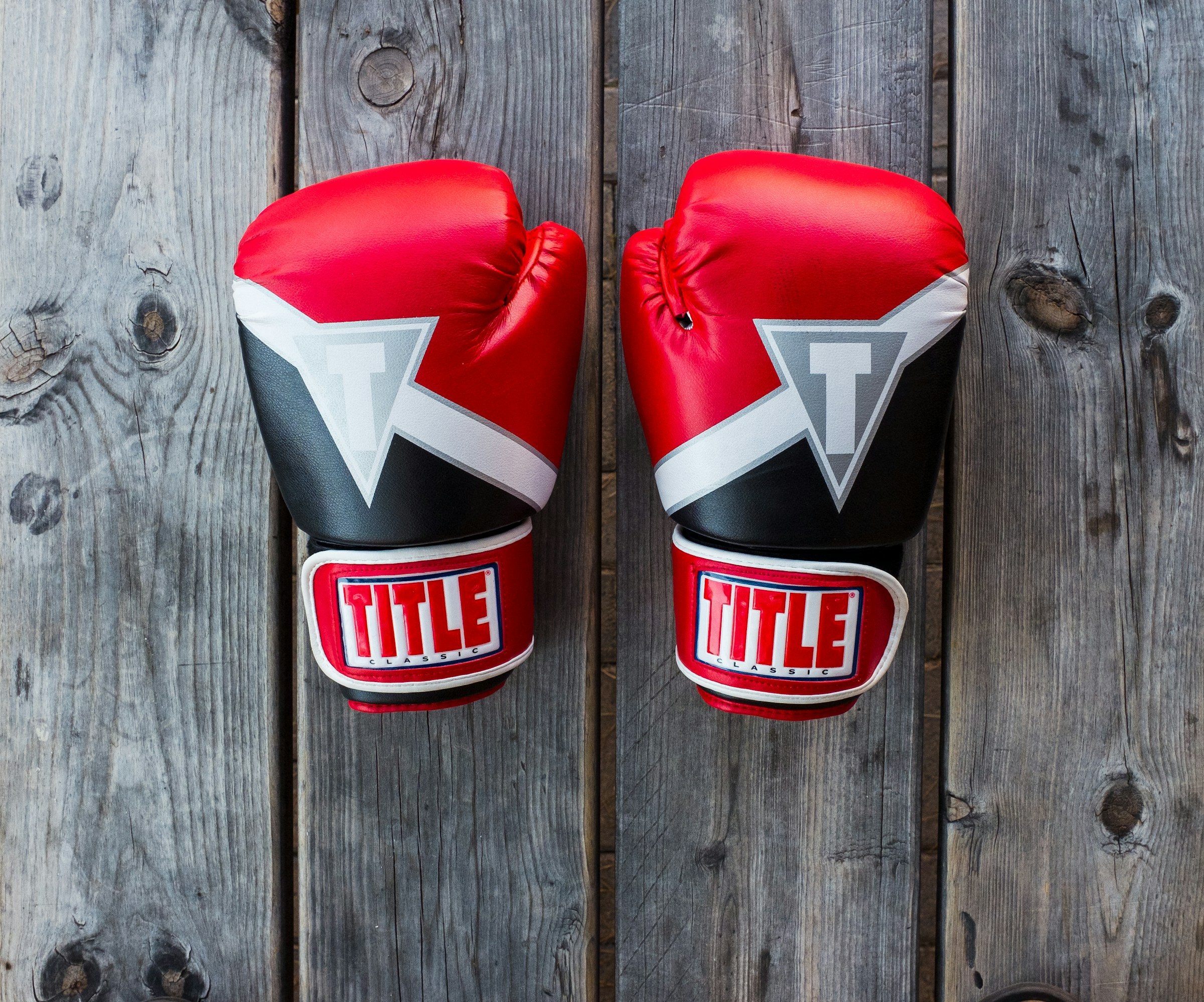 boxing gloves on wooden board